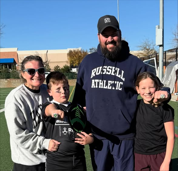 Kate Bodnar with her family at a football field